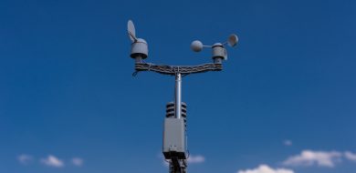Weather station with IoT sensor installed outdoors on a mast, connected via wireless M2M connectivity